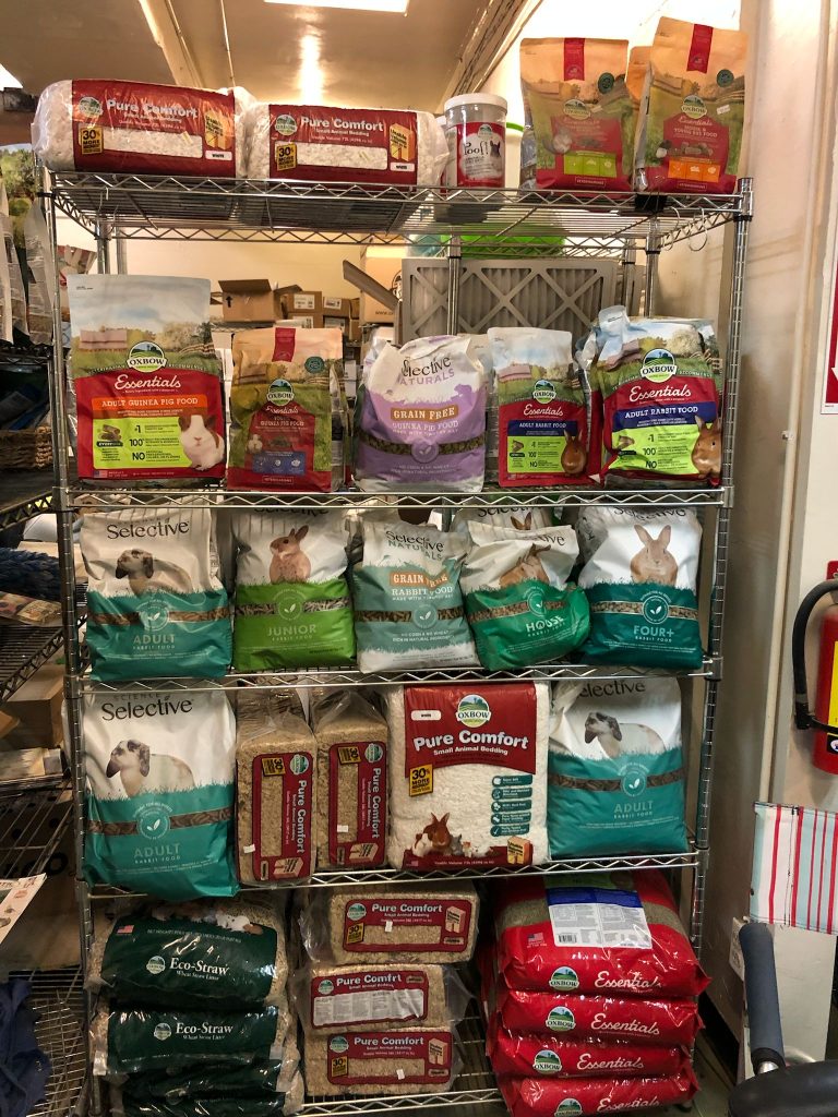 Shelf stocked with pet food bags.